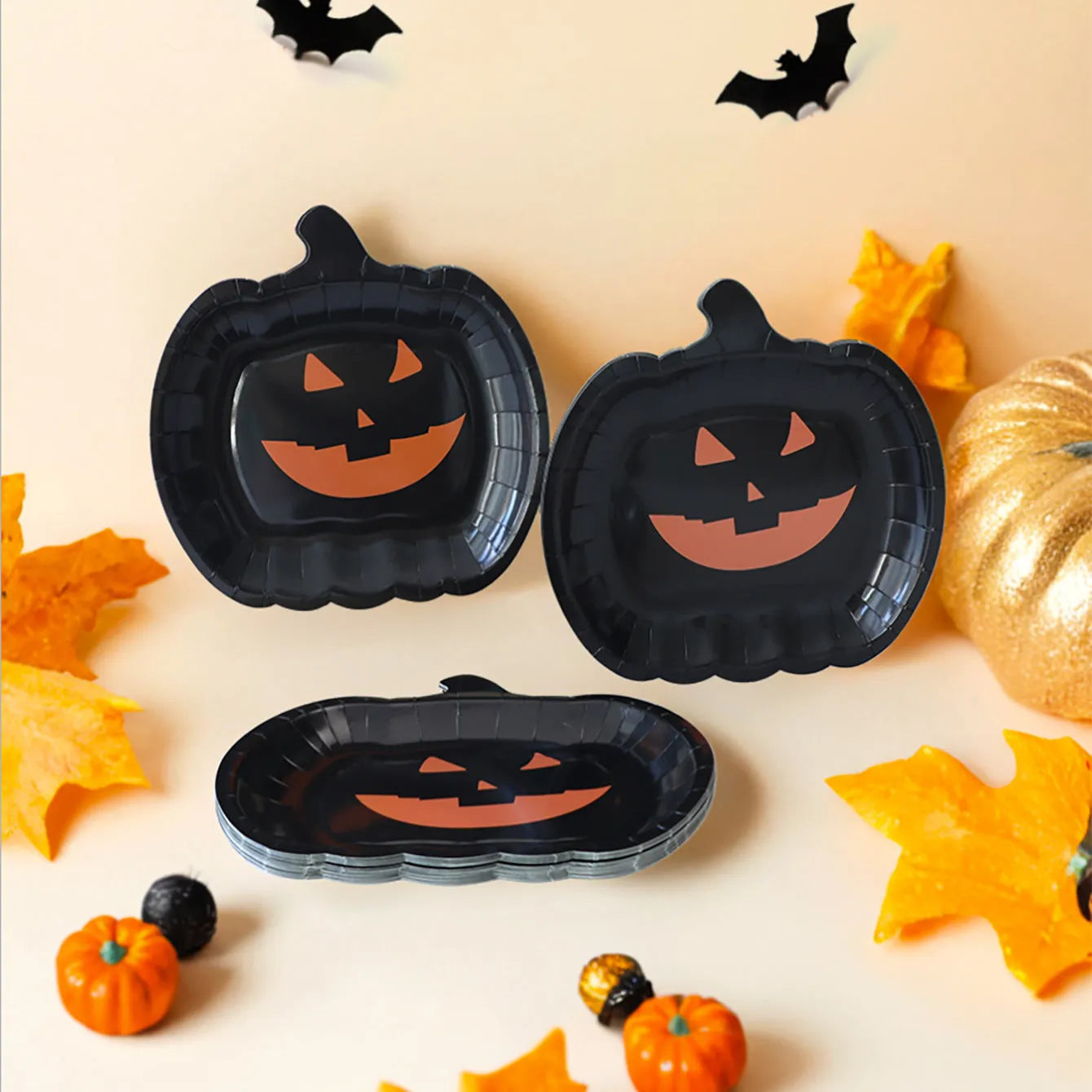 Black Halloween disposable paper plates with pumpkin design in 9-inch size