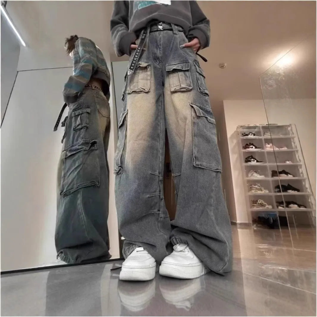 Man wearing loose fit light blue denim jeans with multiple tooling style pockets.