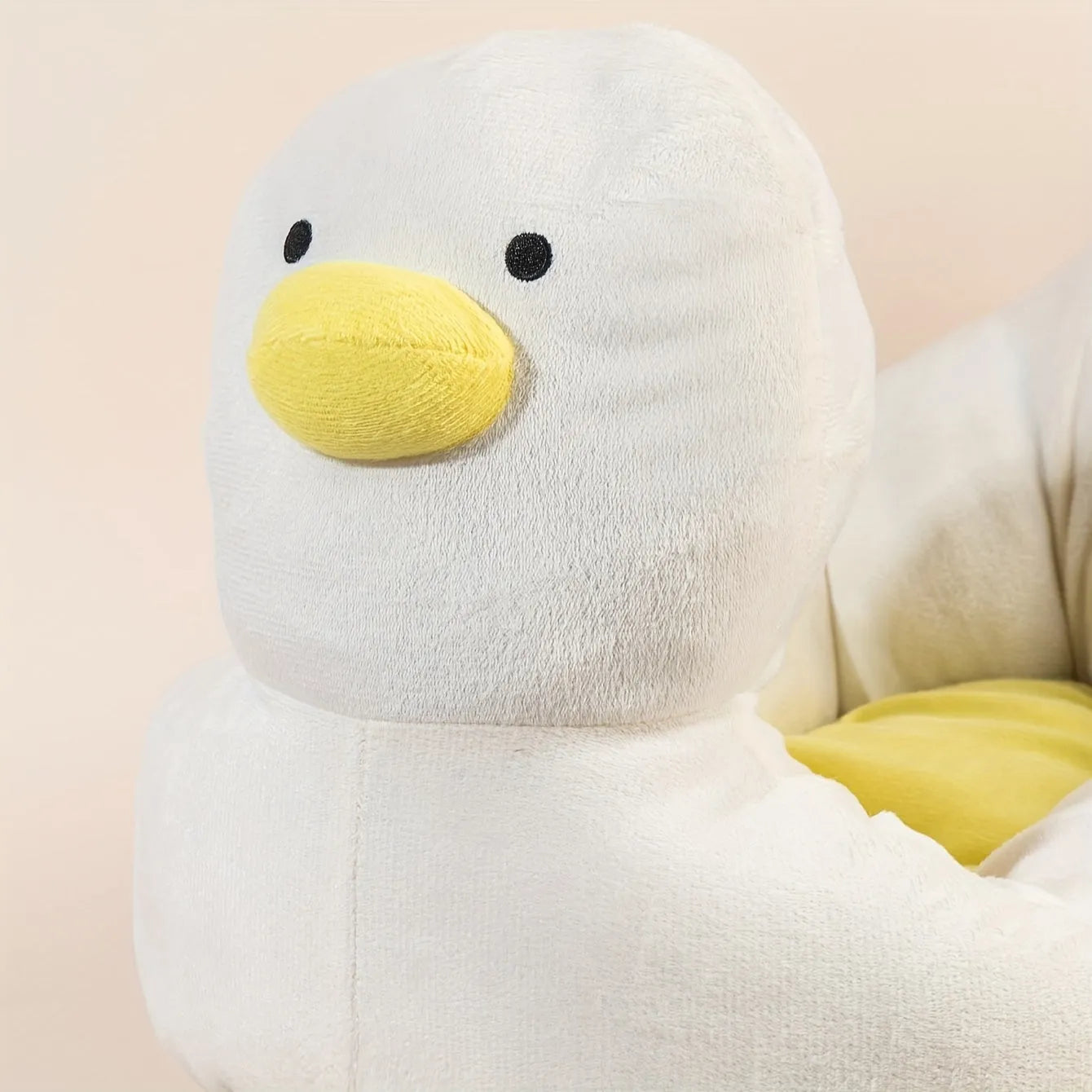 Blue duck-shaped fluffy pet bed for small dogs and cats on a floor
