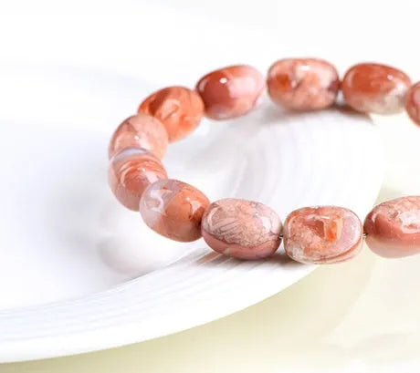 Natural cherry agate bracelet with barrel-shaped beads and Ruyi design element