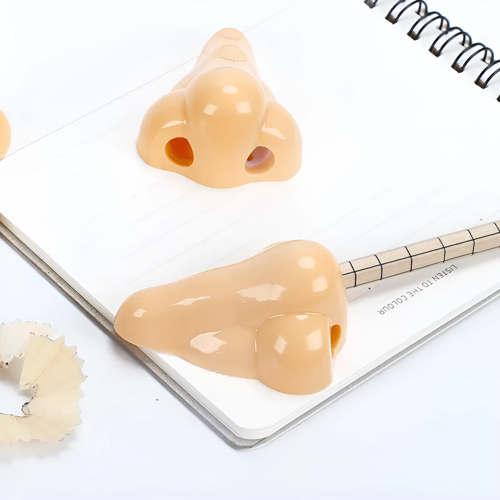 Flesh coloured plastic pencil sharpener with big nostril design for manual pencil sharpening