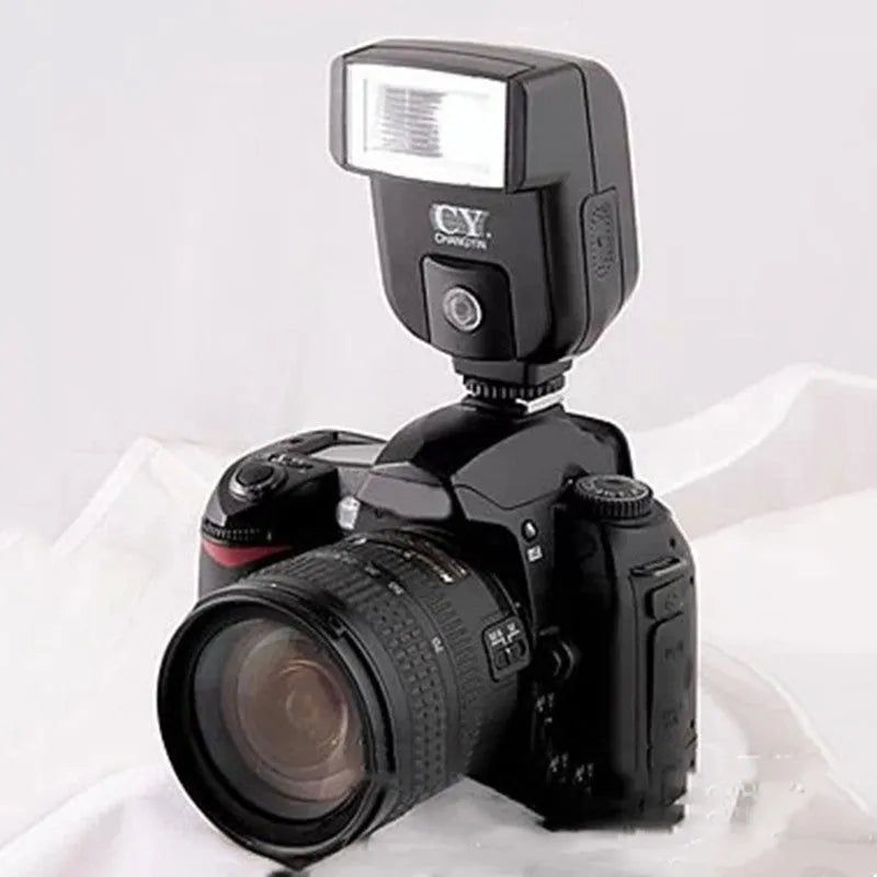 Compact silver SLR camera flash unit tilted on a hot shoe mount.
