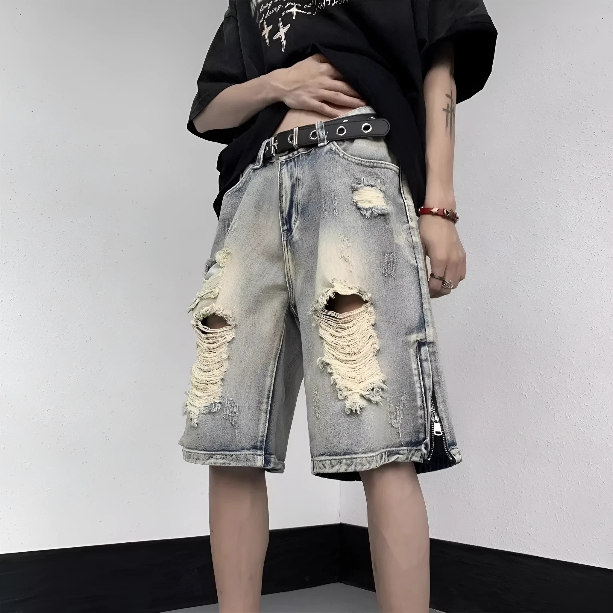 Blue retro tattered denim shorts with a wide leg loose fit on a mannequin.