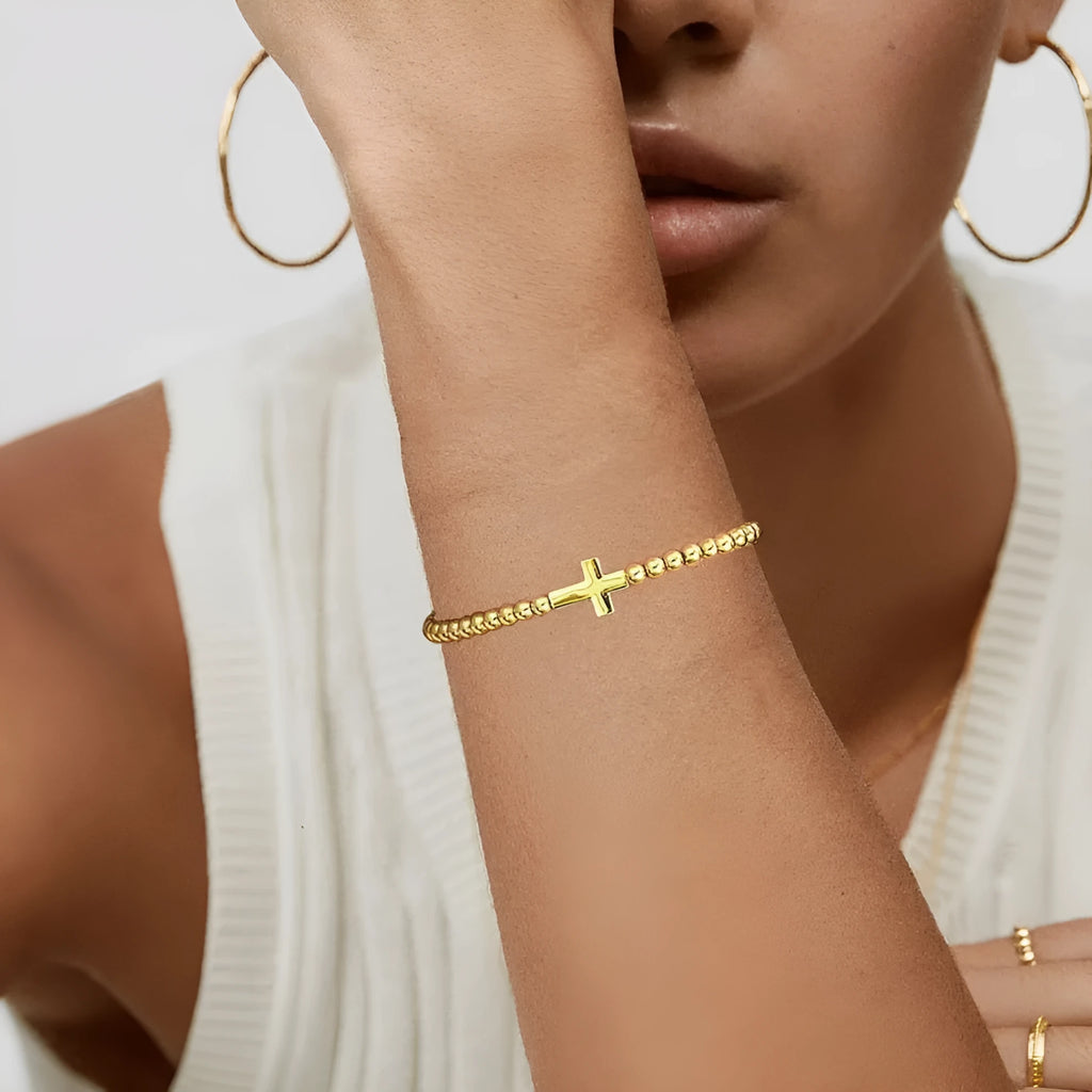 Women's adjustable stainless steel beaded bracelet in a simple geometric shape on a wrist.