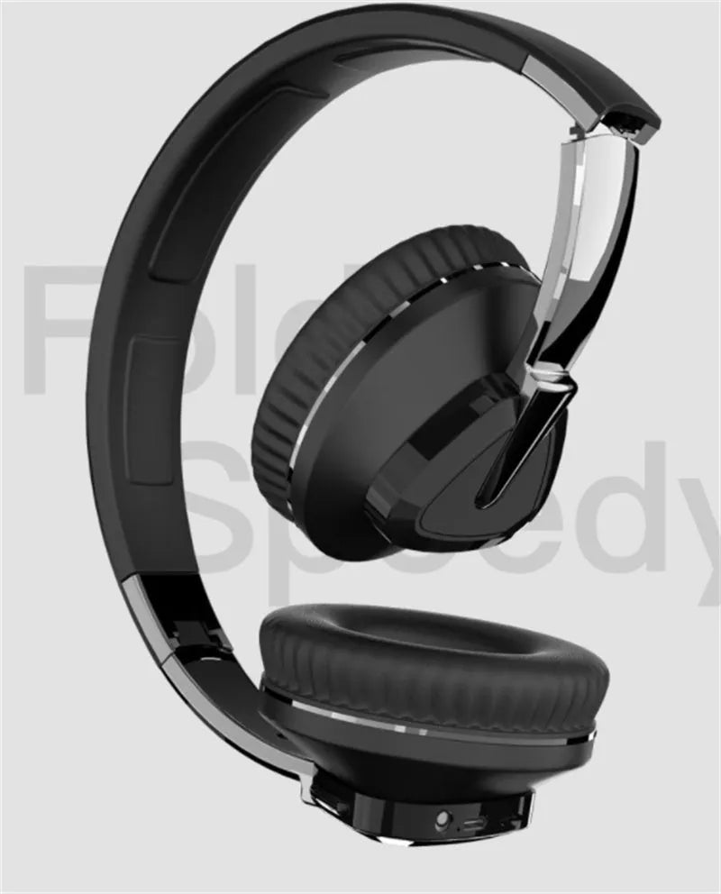 Wireless over-ear headset in black with soft ear cushions, showing AUX audio jack port.
