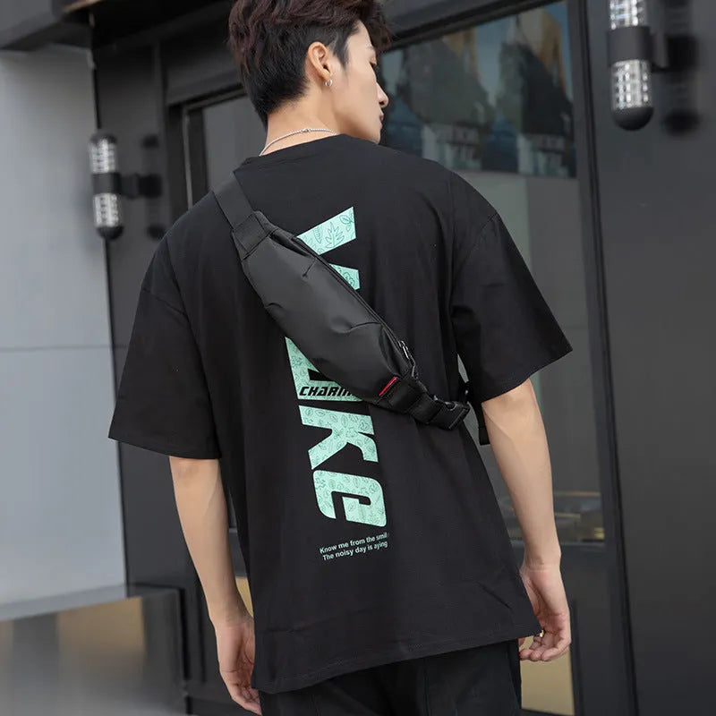 Black oxford cloth men's crossbody bag showing front zipper and internal phone and ID pockets.