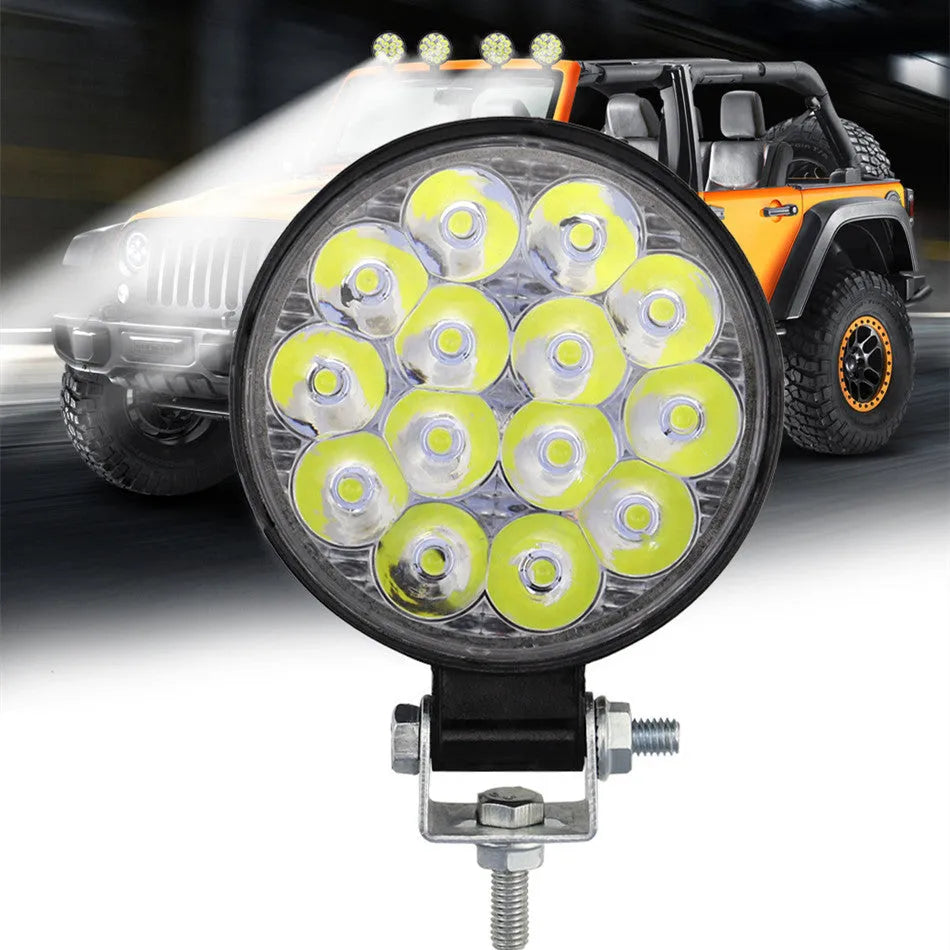 Mini round aluminium car LED work light with white light, shown for off-road vehicle installation.