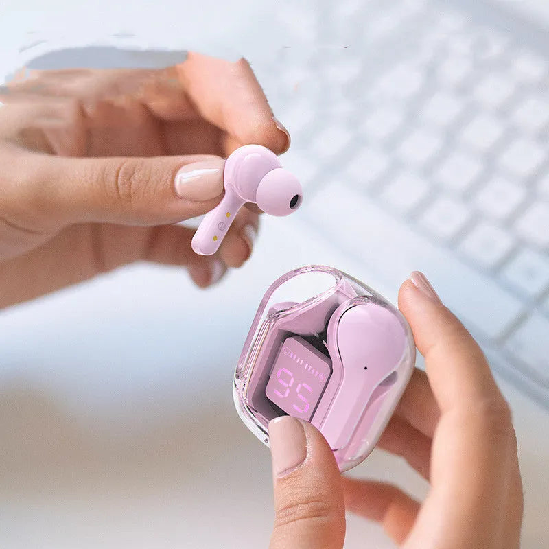 Mini wireless Bluetooth headset in charging compartment with LED battery display, pink colour, silicone case, and USB-C cable