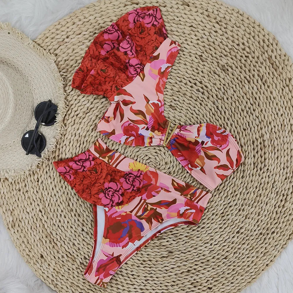 Women's pink one-shoulder ruffled swimsuit with red flower print and high-waisted briefs