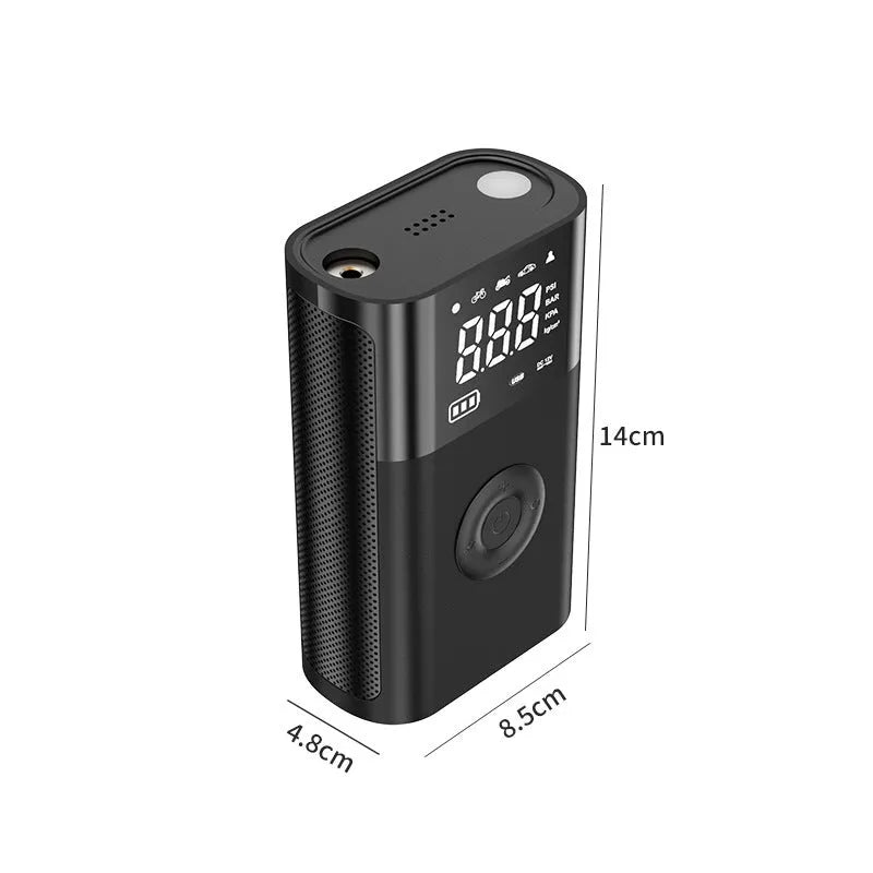 Handheld wireless digital tyre inflator with display screen, LED light, and multiple nozzle adaptors on a table.
