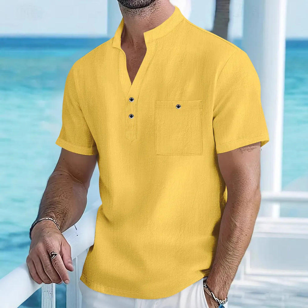 Man wearing a light-coloured linen stand collar t-shirt with short sleeves in a loose fit
