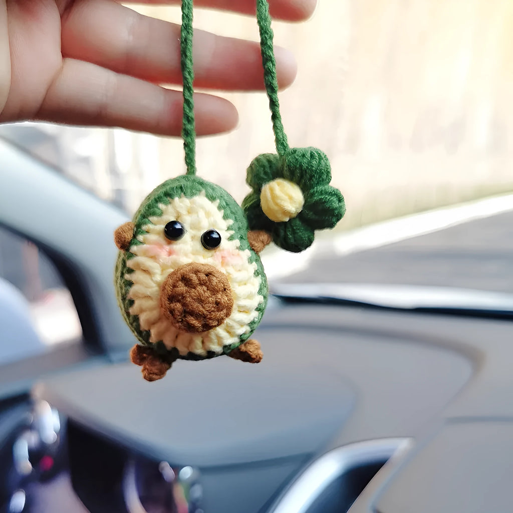 Handmade crocheted rainbow flower car pendant in wool yarn with avocado, pink, and red colour options