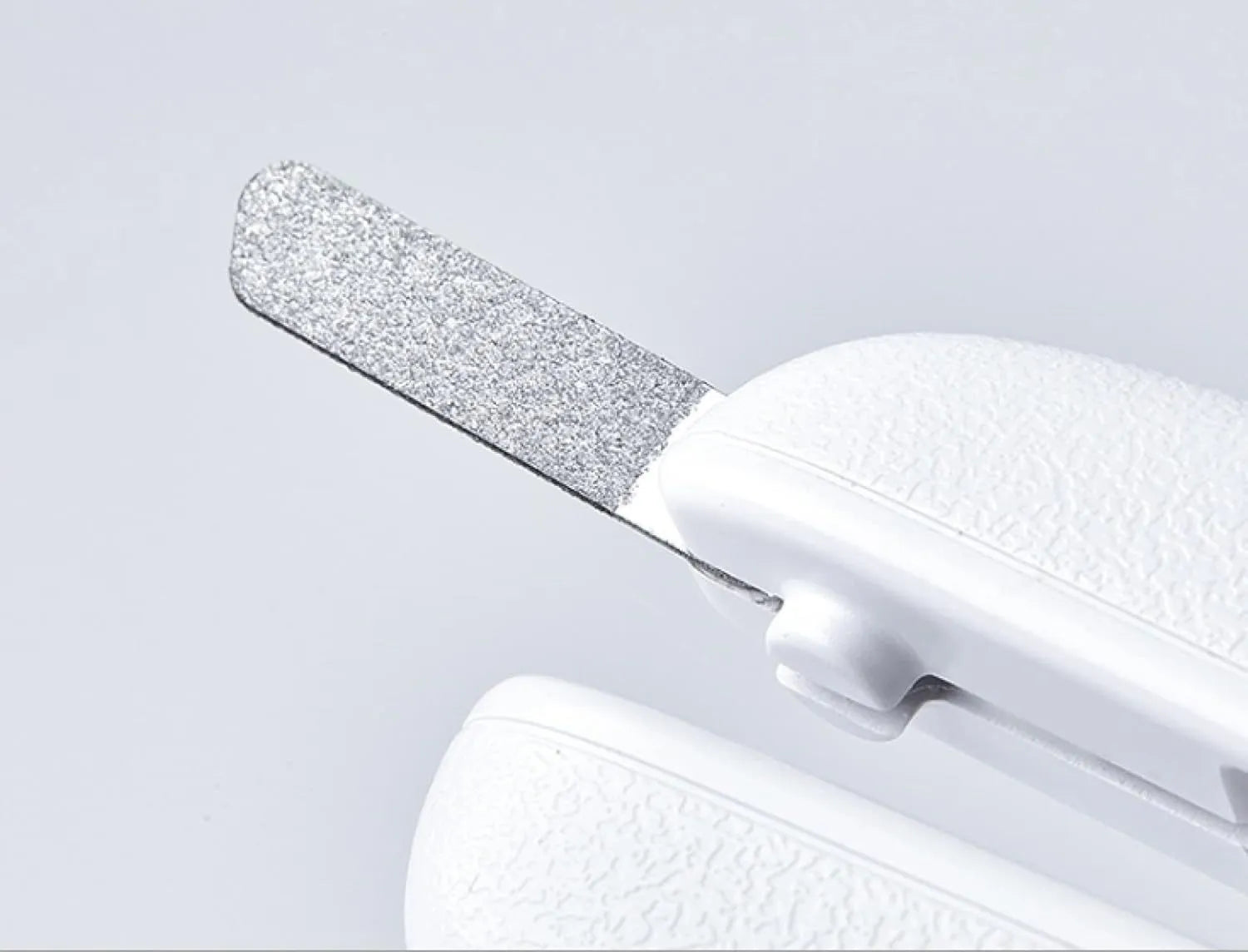 White pet nail clippers with LED light, anti-splash transparent guard, and a leather-like handle on a blue background.