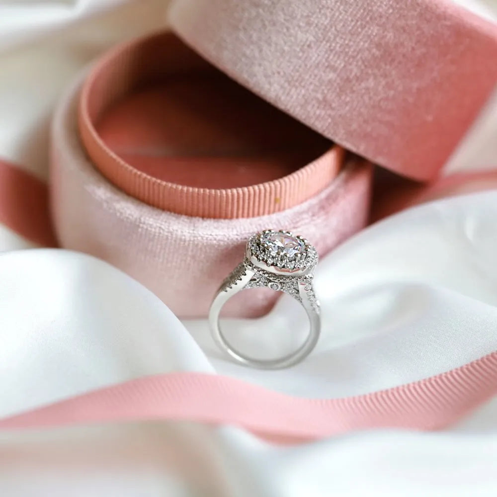 Silver ring with round rhinestone zircon centre on a plain background, women's affordable luxury style