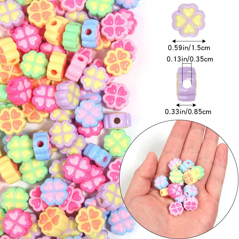 A selection of 15mm frosted acrylic beads showing a raised cartoon love and four-leaf clover pattern in various colours.