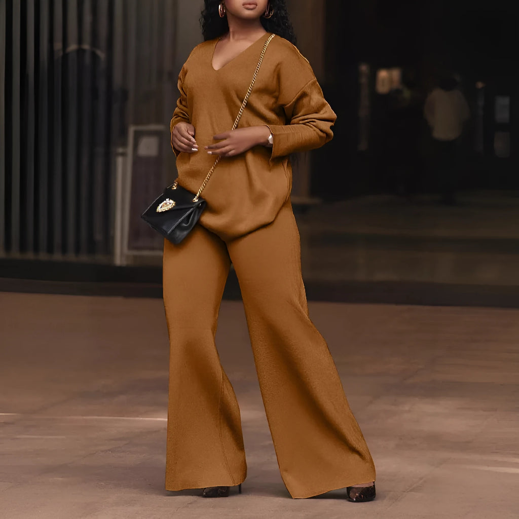 Women's brown suede two-piece casual suit with long sleeves and trousers on a hanger