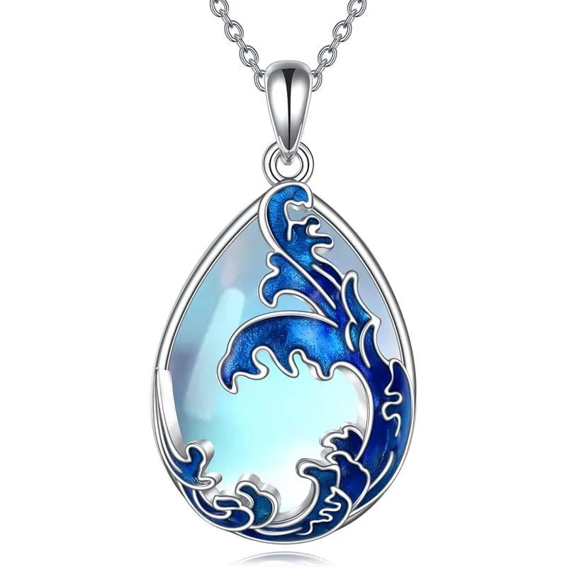 Blue heart pendant necklace on silver-tone chain with moonstone blue finish