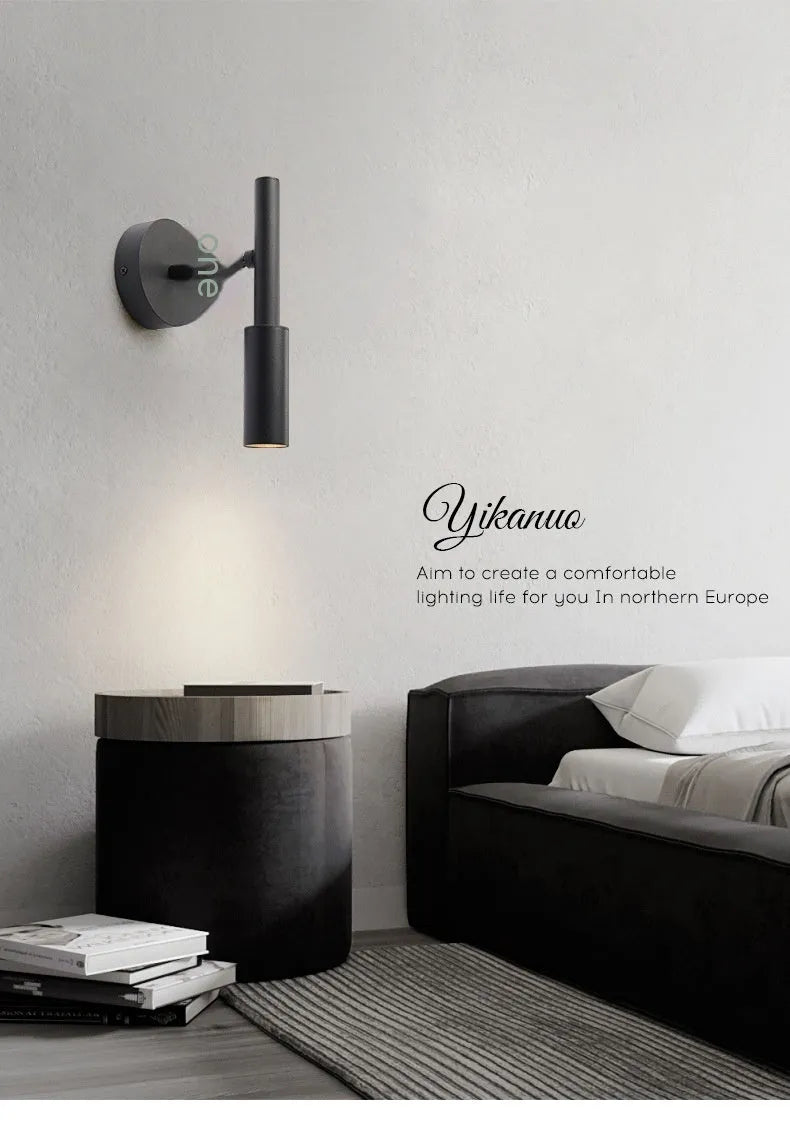 Modern wrought iron wall lamp in black or white finish, showing three colour light options.