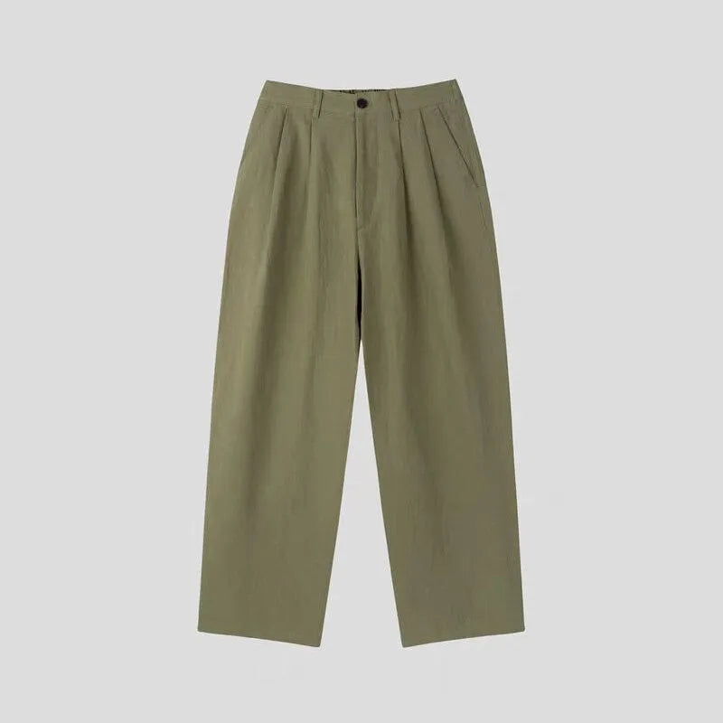 Men's loose-fit apricot cotton linen trousers with wide-leg Korean style on a neutral background.