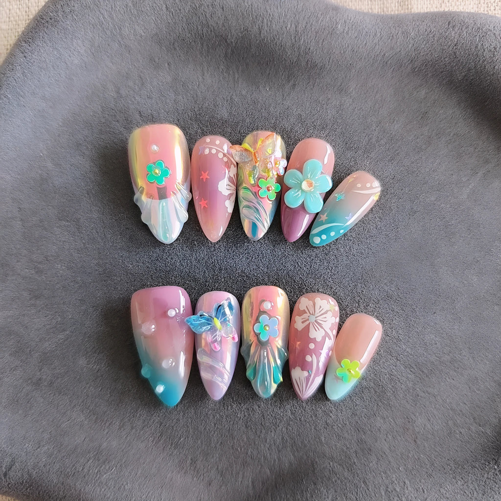 Handmade nail art sculptures with embossed floral and butterfly patterns in almond shapes