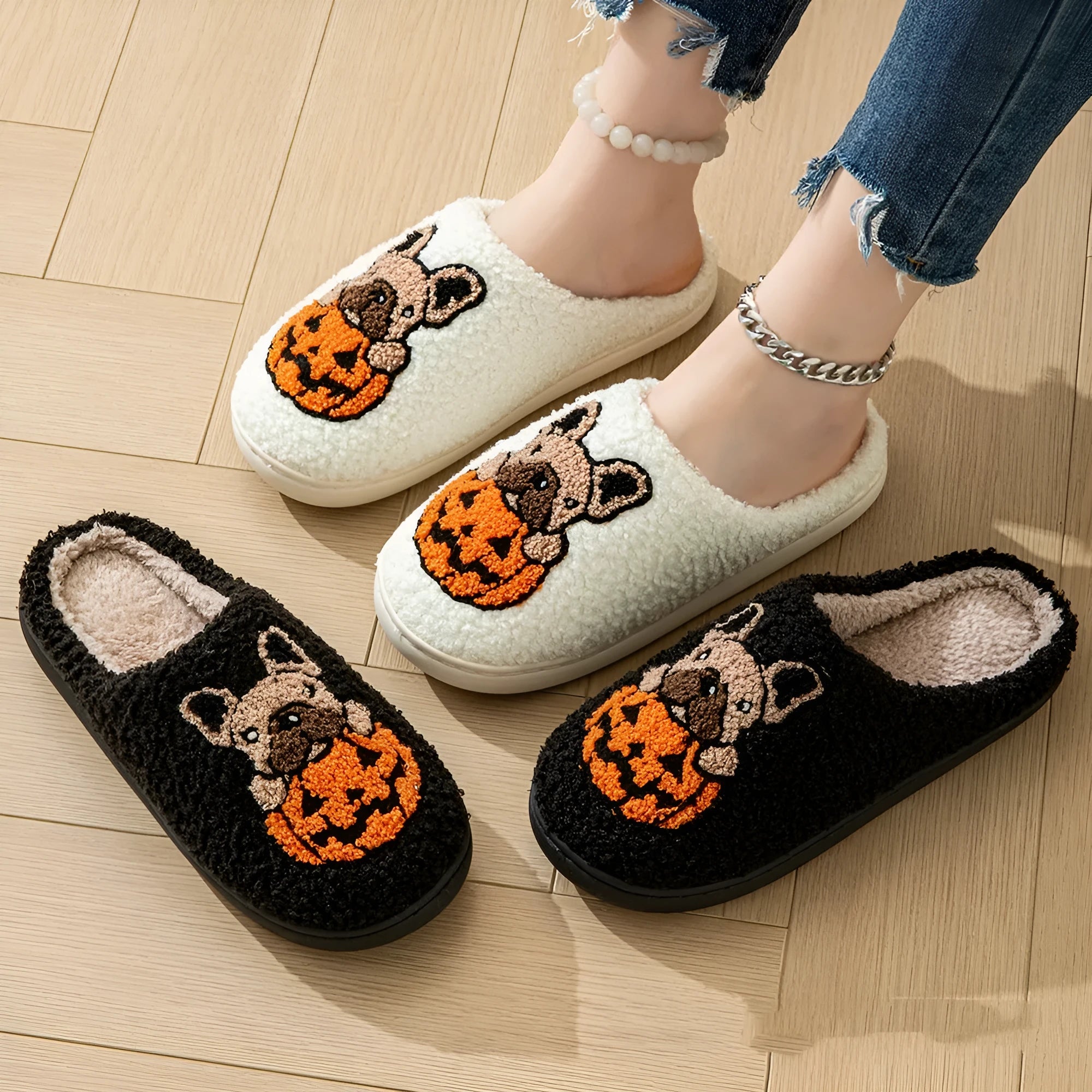 Black and white Halloween pumpkin plush slippers with round toe design and TPR rubber soles