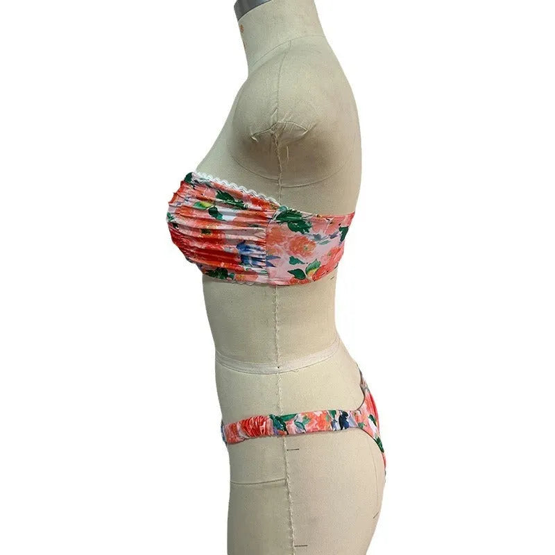A colourful floral print lace tube top bikini set with matching shorts on a mannequin.