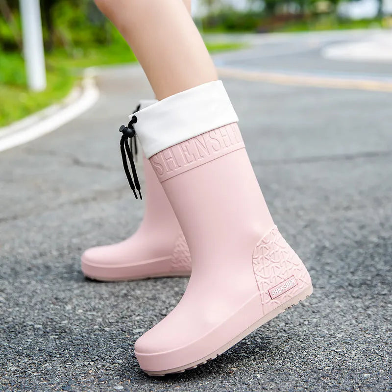 Women's solid colour PVC rain boots with non-slip soles in apricot, black, brown, and pink waterproof mouth designs