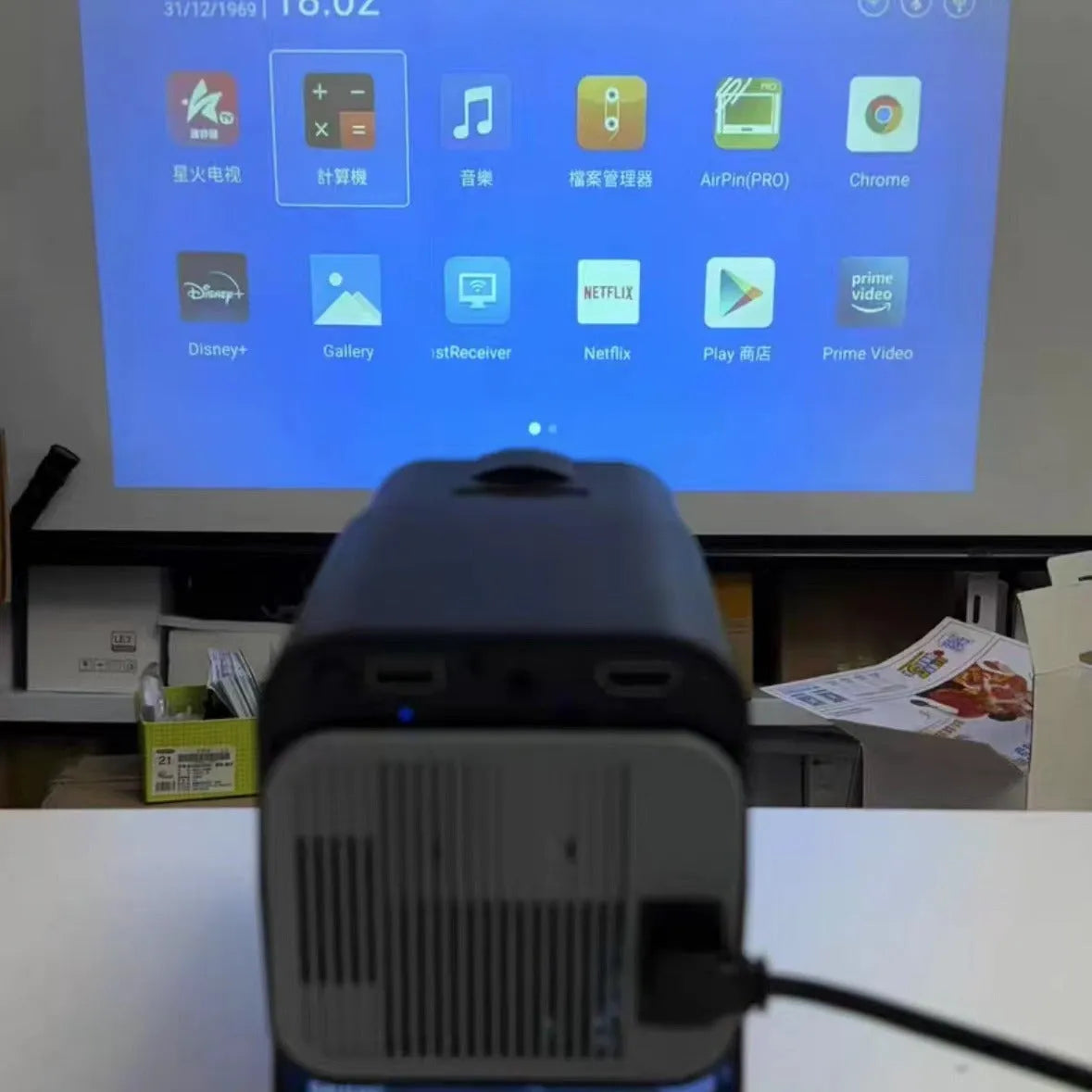 Wireless game machine projector with 720p HD resolution showing international power compatibility symbols