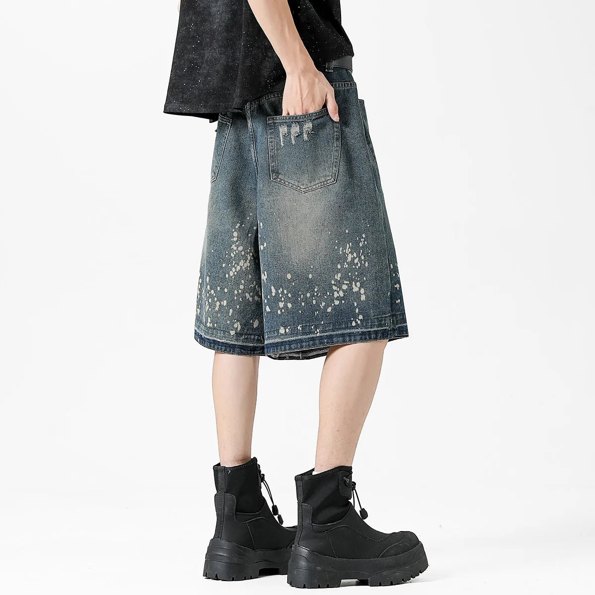 Retro blue denim shorts with distressed rip details and splash ink patterns, straight leg cut