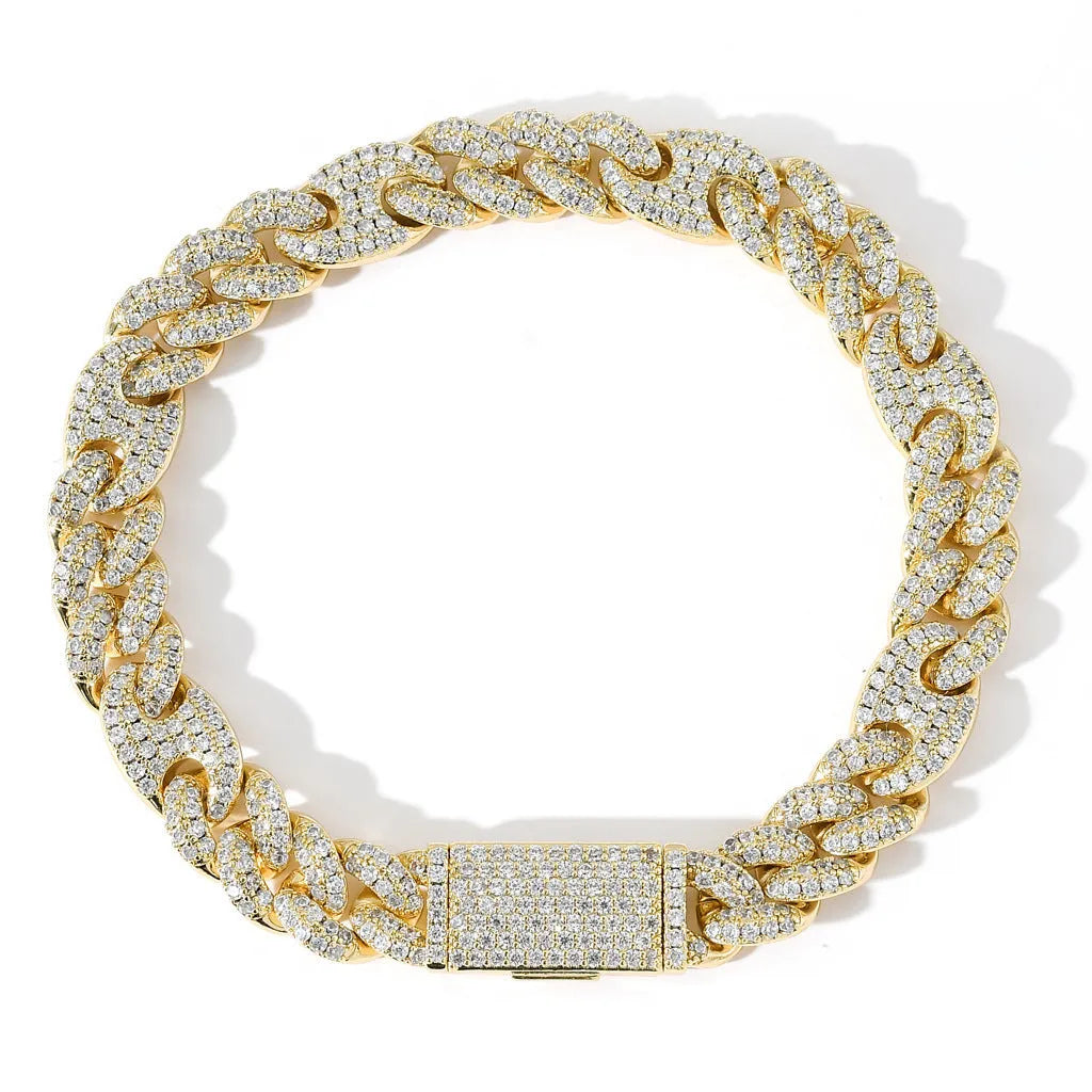 Micro inlaid zircon Cuban chain hip hop bracelet in gold and silver on a flat surface
