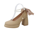 Women's beige Mary Jane shoes with chunky heel and ankle-strap buckle on a neutral background
