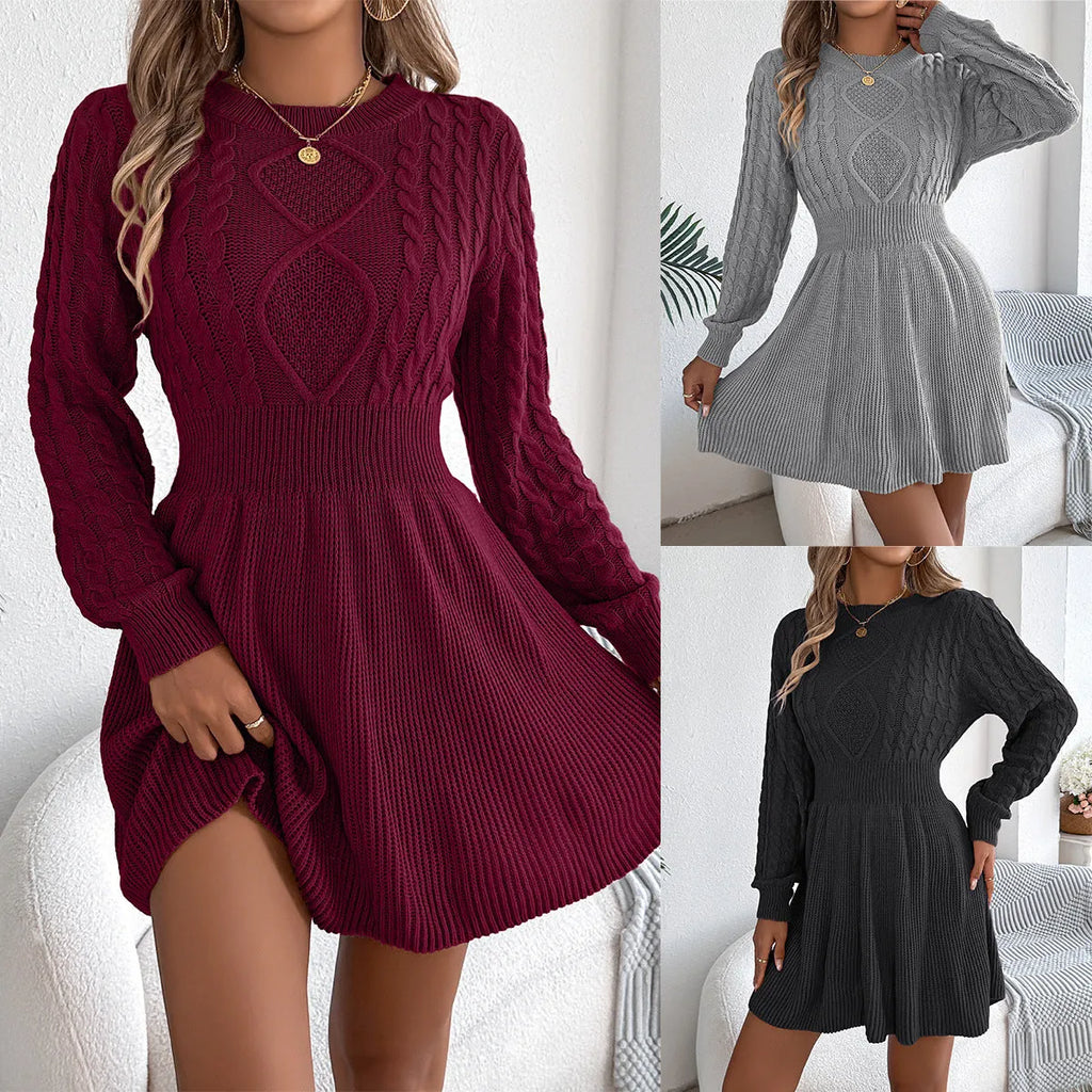 A woman wearing a wine red lantern sleeve sweater dress with an elastic waist.