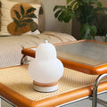 White pear rechargeable LED touch table lamp with PE shade on a bedside table