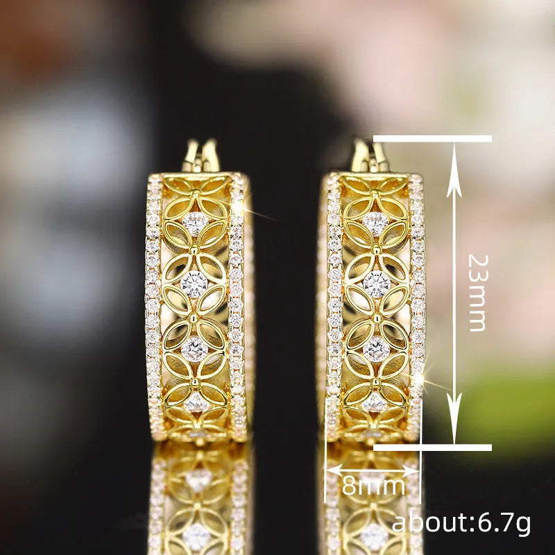 Yellow gold geometric copper earrings with horse eye, flower and butterfly motifs, clip-on back visible