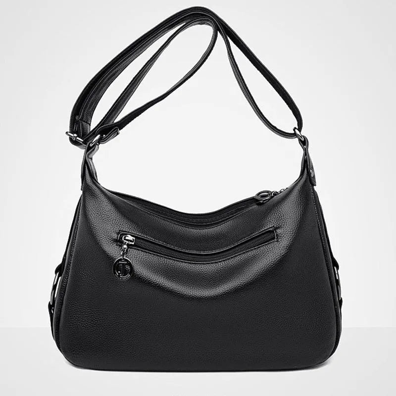 Large blue PU leather crossbody bag for women showing horizontal square shape and internal organiser pockets.