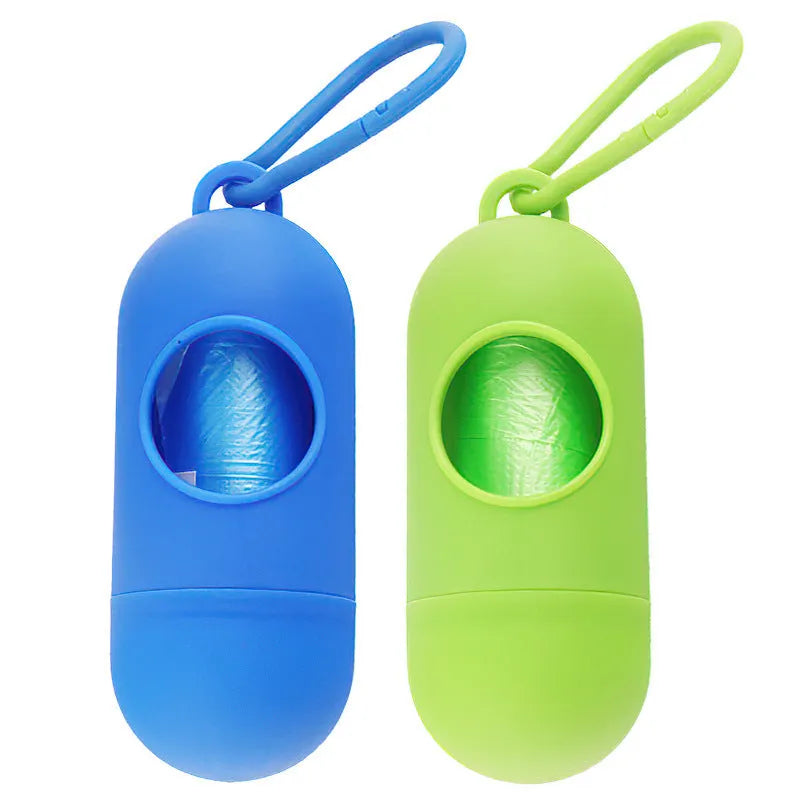 Compact black dog poop bag holder with a metal hook and Velcro strap, showing scale.