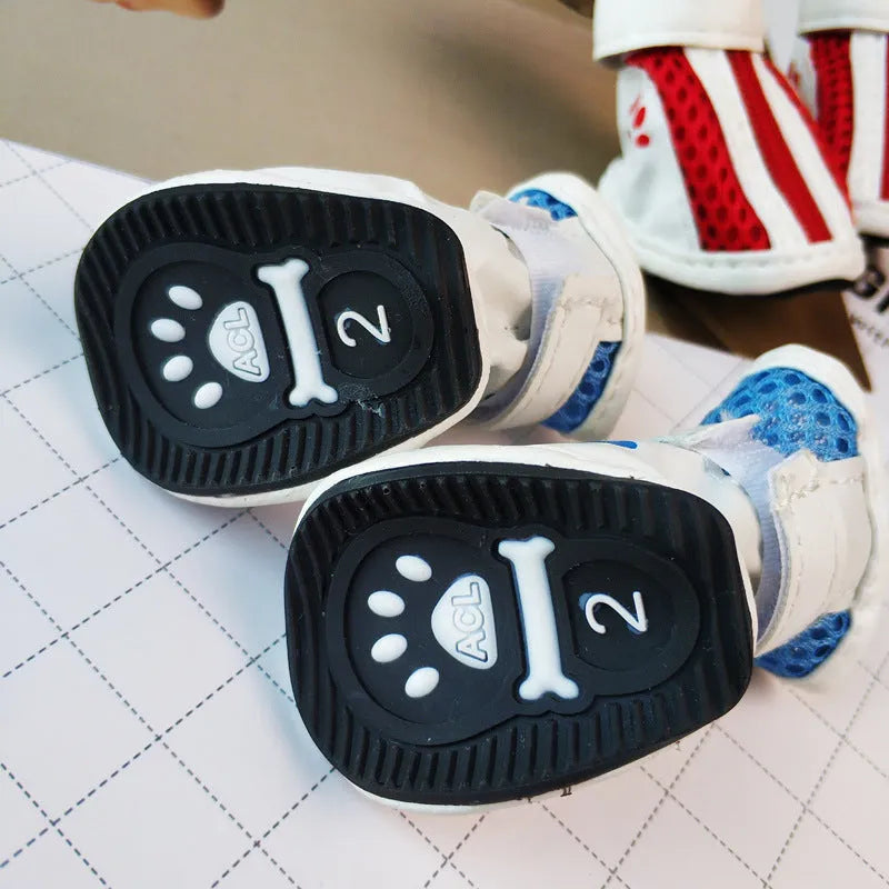 Set of four blue cloth dog shoes with side zips for small breed pets.