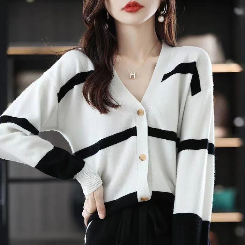 Women's black and white striped V-neck knitted cardigan with 3D pattern and buttons.