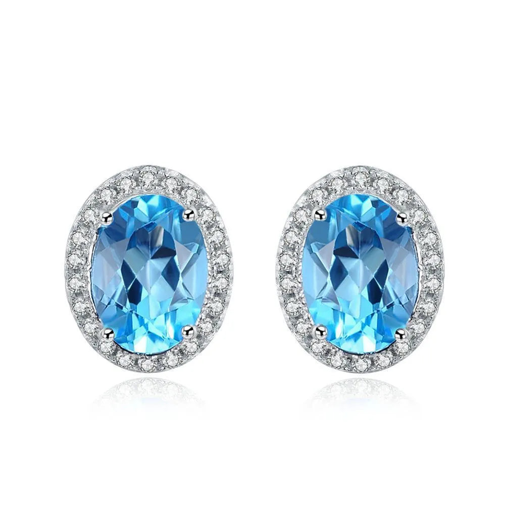 Geometric 925 sterling silver jewellery set with blue topaz stones, showing necklace, earrings, ring, and pendant.
