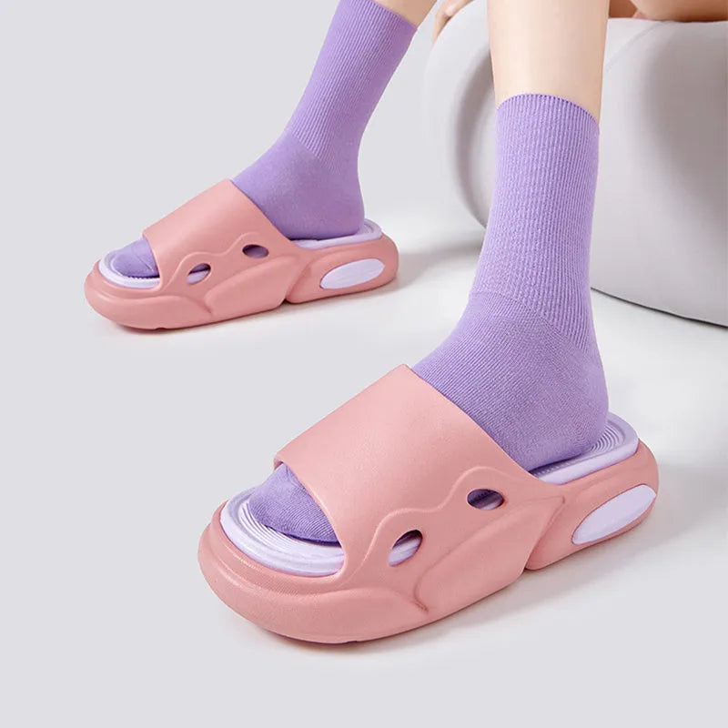 A pair of unisex EVA foam slippers with a thick sole and leather lining, shown in a two-colour design.