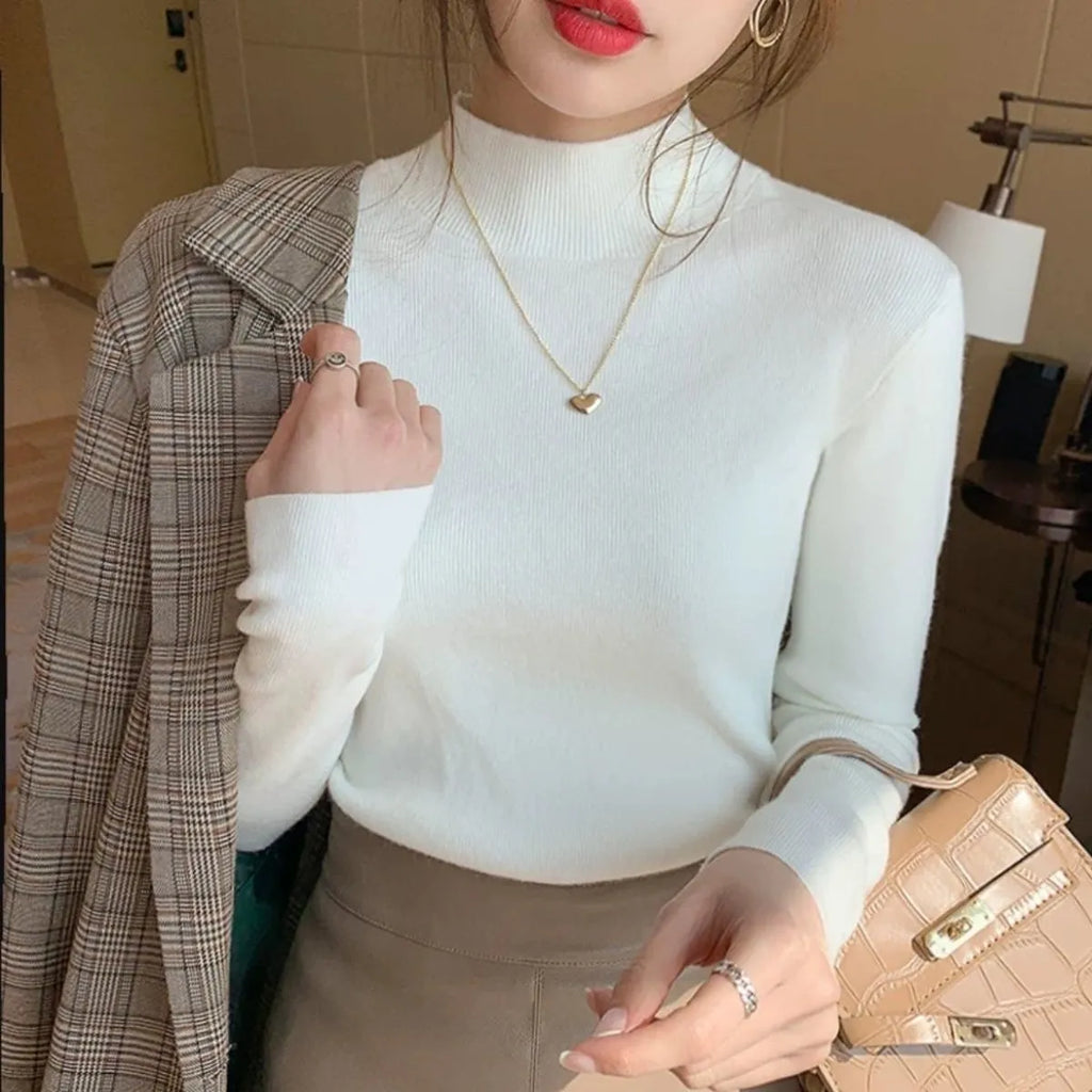 Viscose slim fit long sleeve pullover top in apricot colour on a hanger