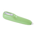 Dark green vegetable peeler with a storage tube and stainless steel blade on a kitchen counter.