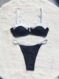 Women's black low waist bikini swimsuit with stitching split detail on mannequin