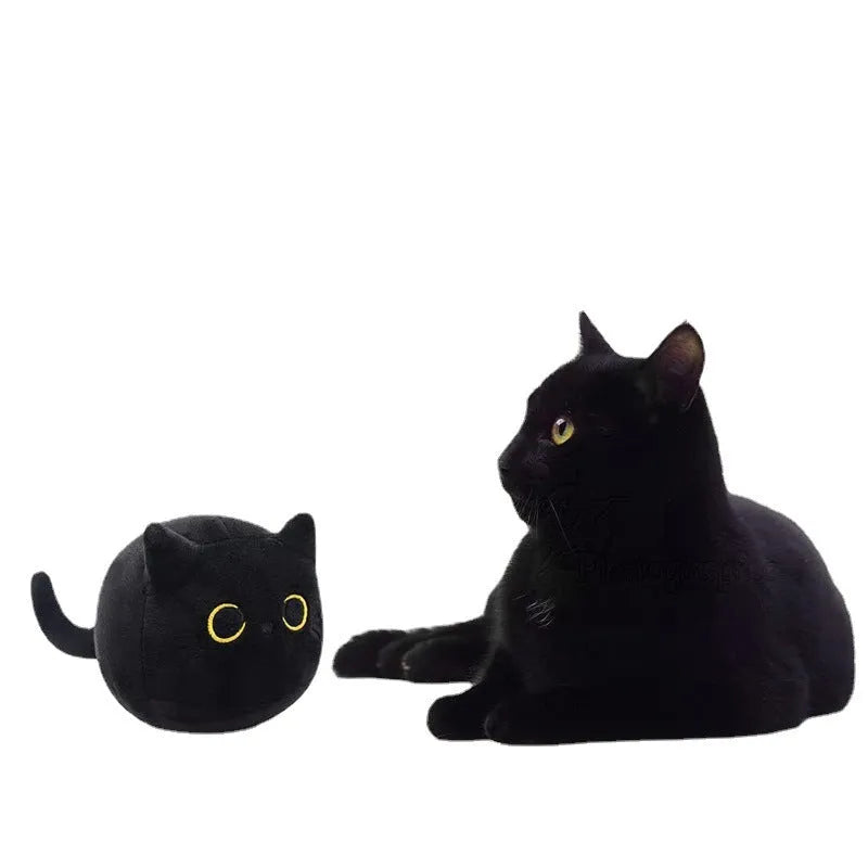 Fluffy black cat plush toy stuffed animal cushion on a sofa