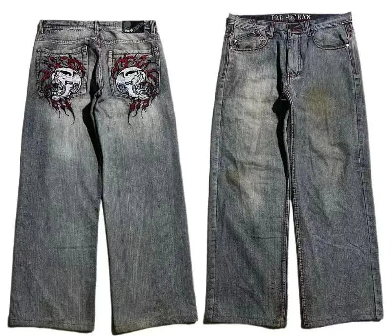 Grey washed-out denim jeans on a man, showing wide-leg straight cut and mid-waist fit.