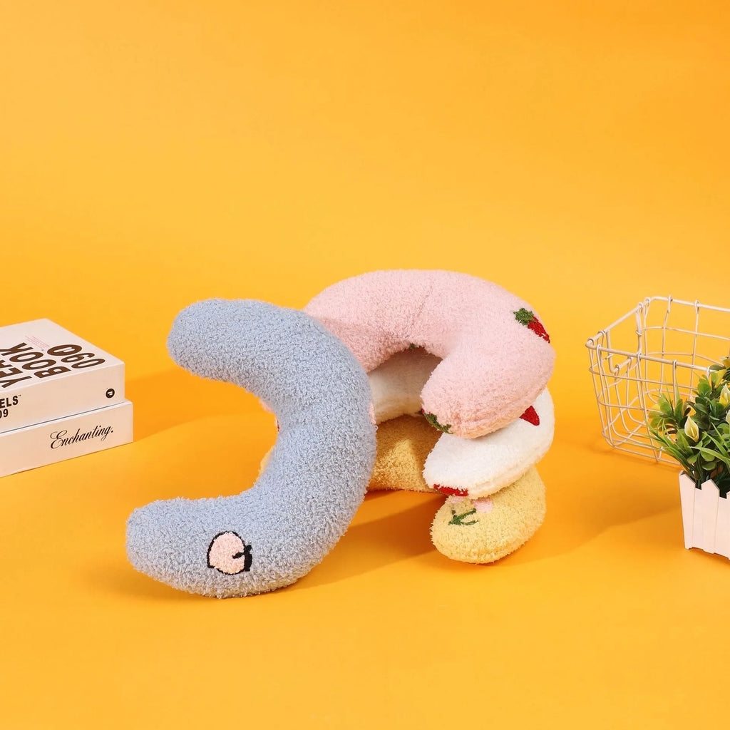 Half moon U-shaped cloth pillow for cats in blue, pink, white, and yellow colour options.