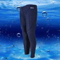Men's nylon cropped swimming trunks in a black and green colour block design, laid flat.
