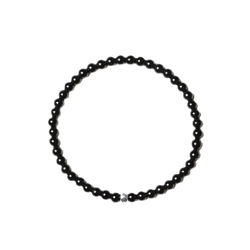 Unisex bracelet with black obsidian, blue San, and agate beads in round and square geometric shapes.