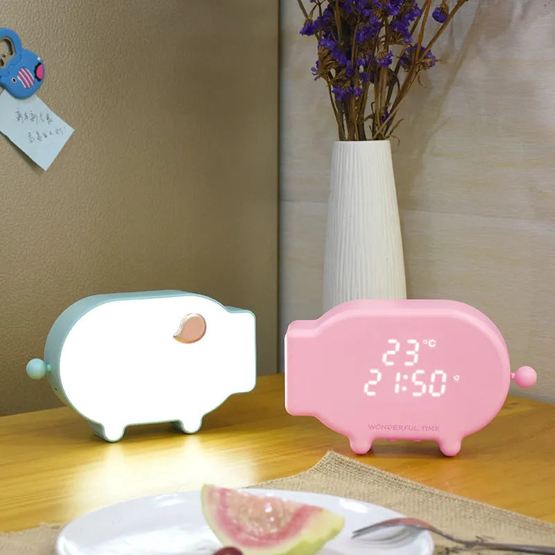 Blue and pink multifunctional LED digital alarm clock displaying time and temperature, with USB charging cable