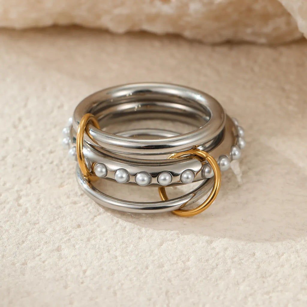 Three stacked stainless steel rings with 18K gold plating in matching design